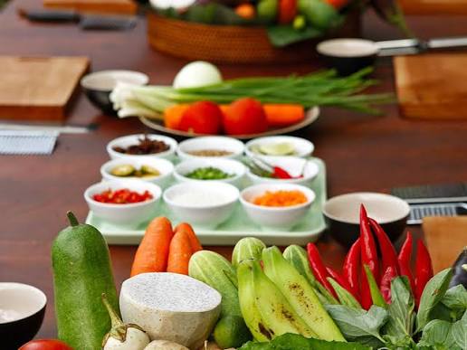Fresh vegetables, herbs and seasonings laid out for cooking