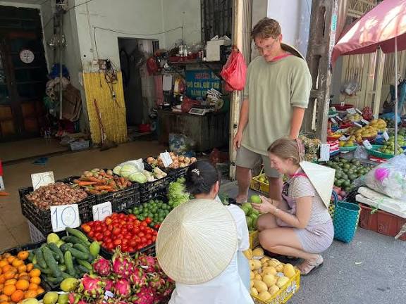 Travellers selecting fresh produce at a local market