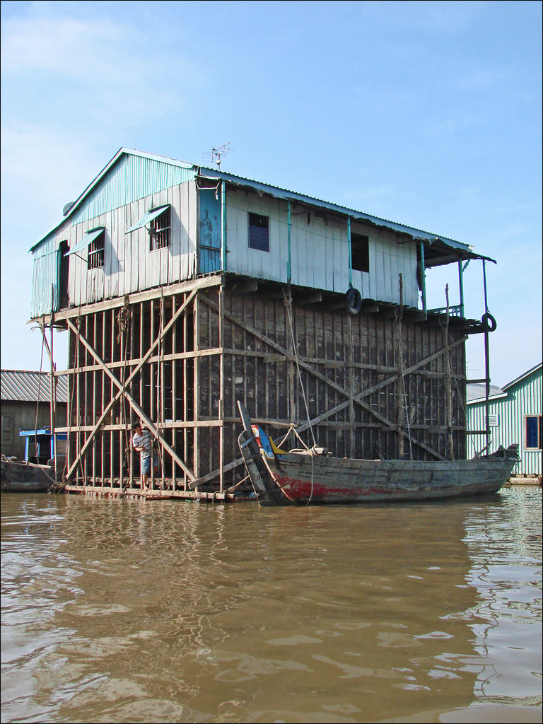 Timber framework below a floating house undergoing repair in Chau Doc