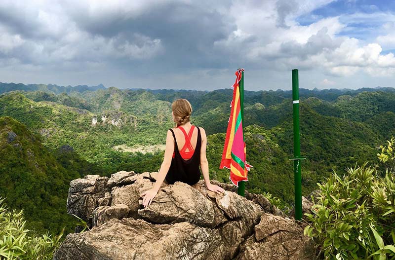 Visitor overlooking forested mountains from Ngu Lam Peak