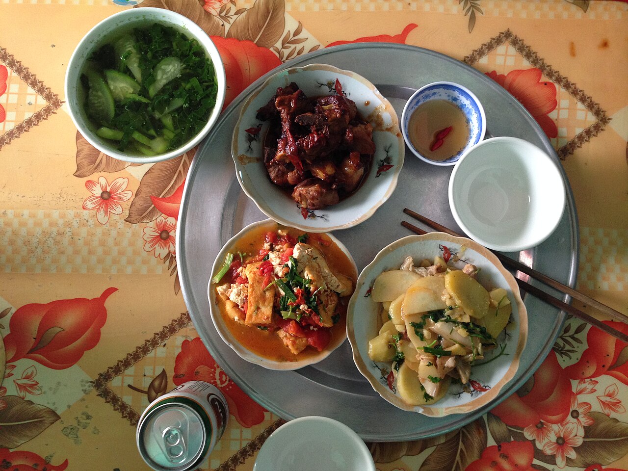 Illustrative Vietnamese home meal with vegetables and tofu; not photographed on Cat Ba.