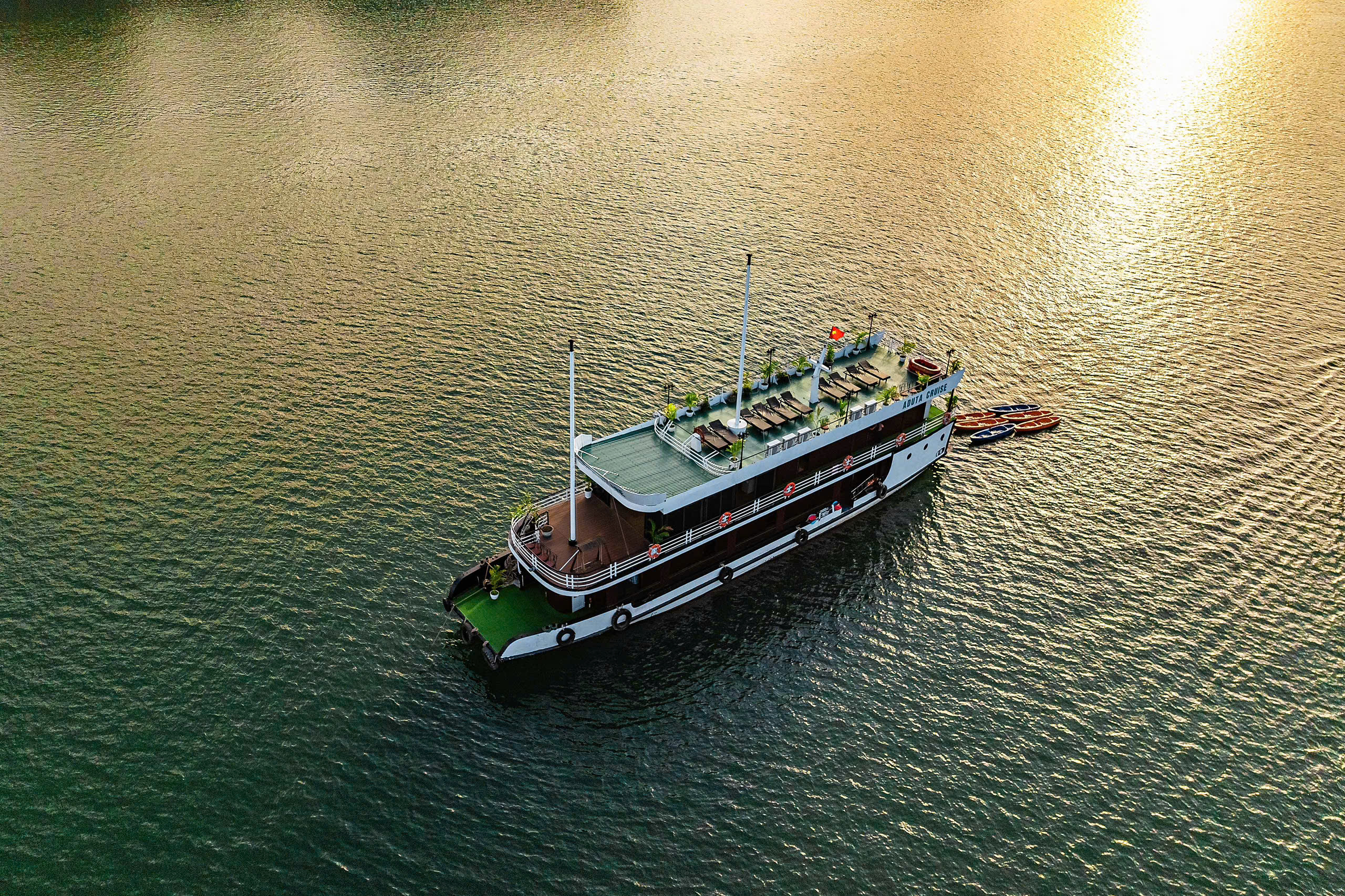 Overnight boat on the bay in golden light