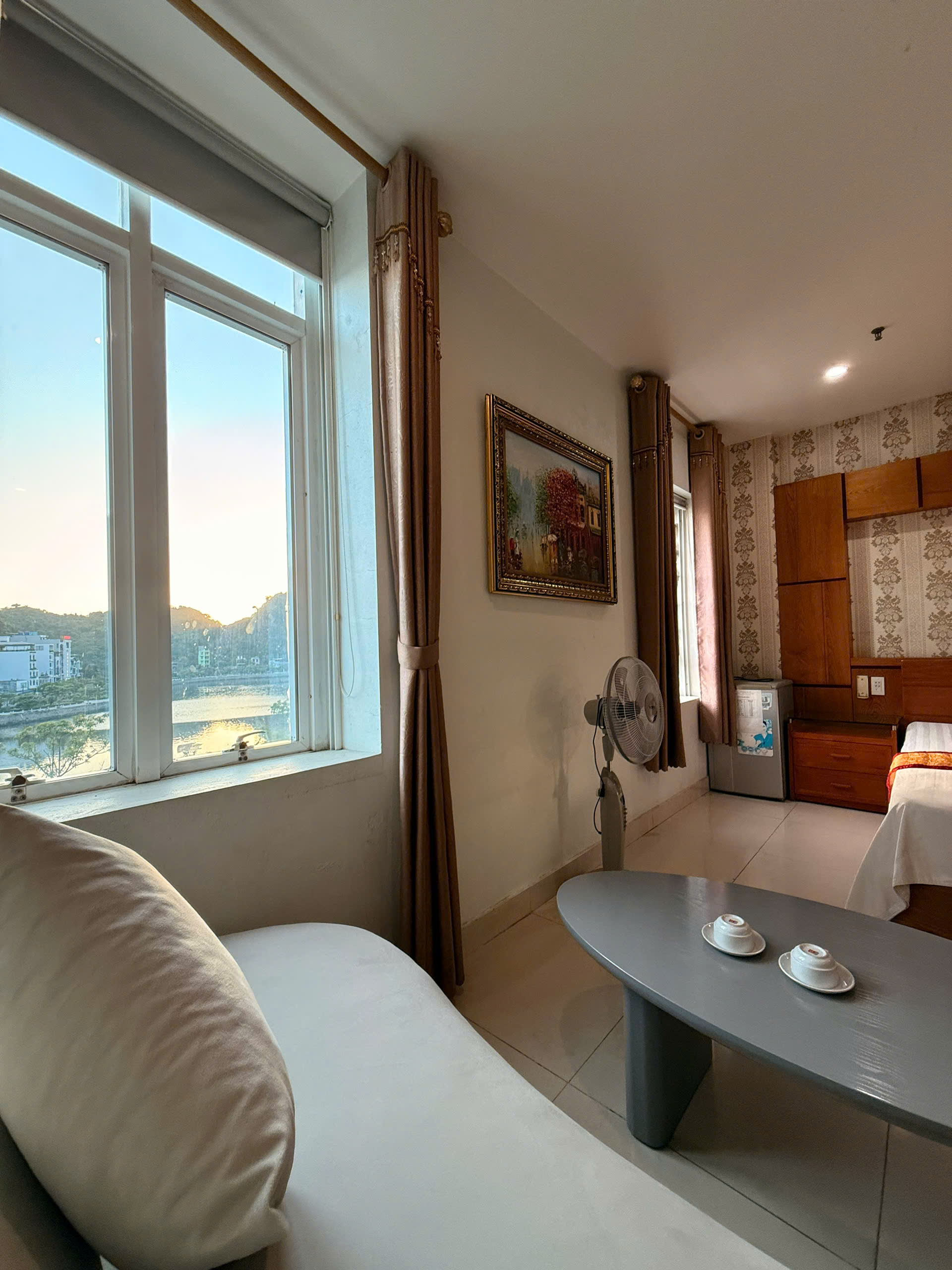 Hotel room sitting area with a window view over the Cat Ba waterfront