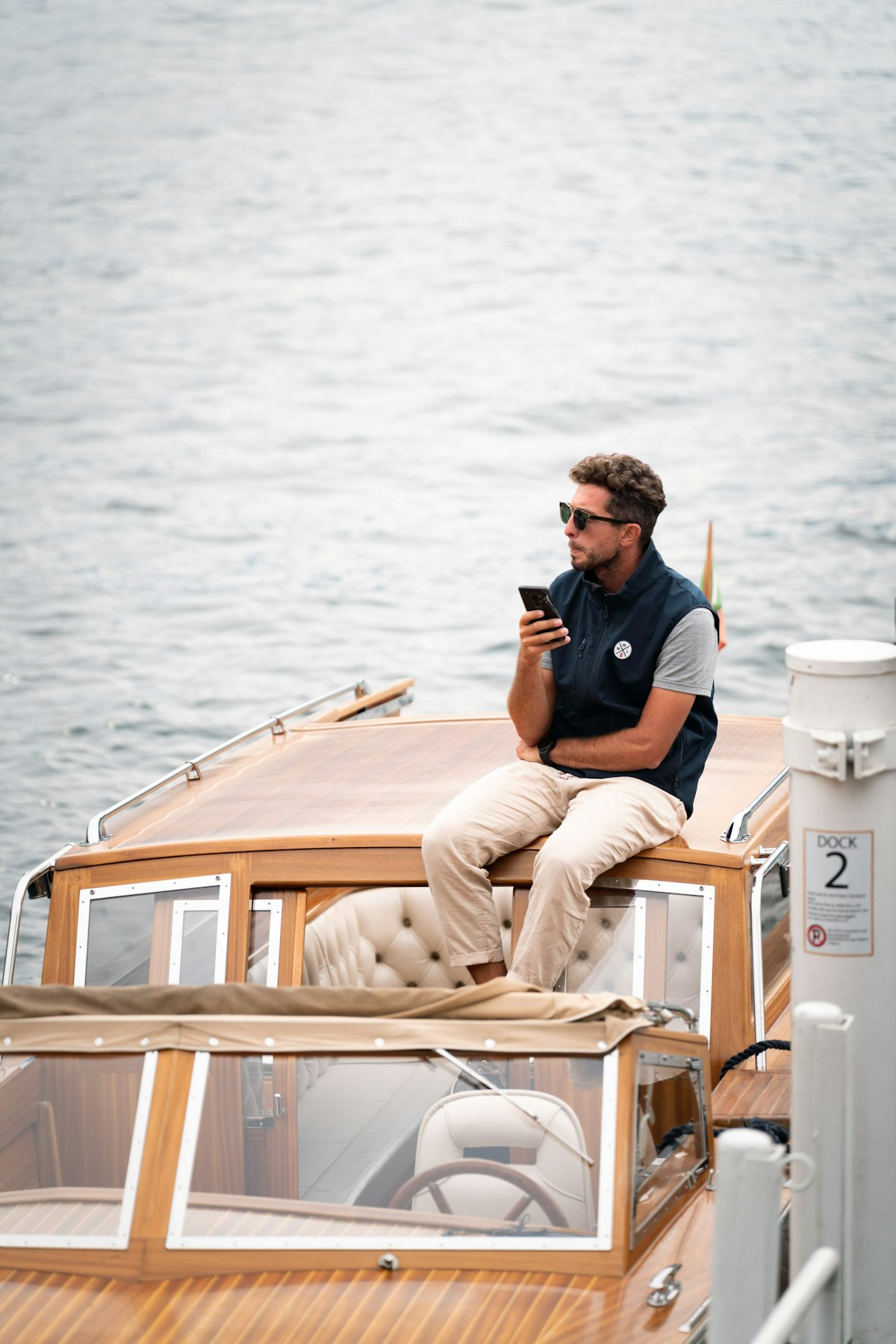 Traveller using a mobile phone on a boat