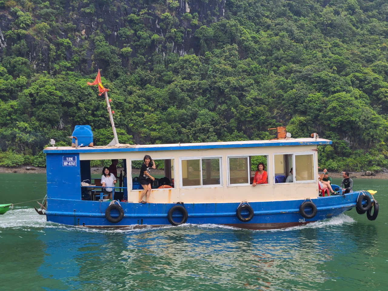 Local passenger boat crossing Lan Ha Bay